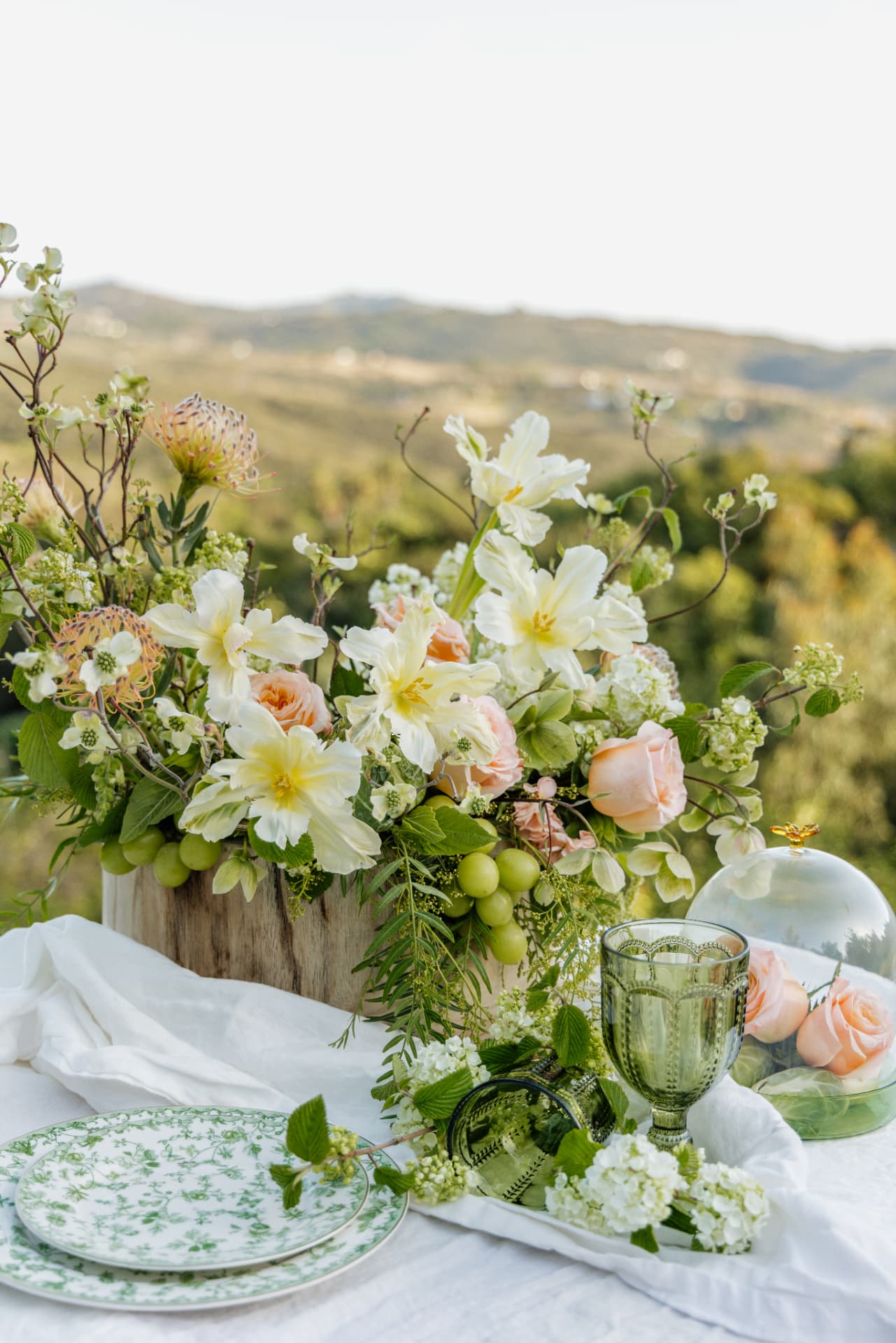 White and peach wedding flowers arranged outdoors